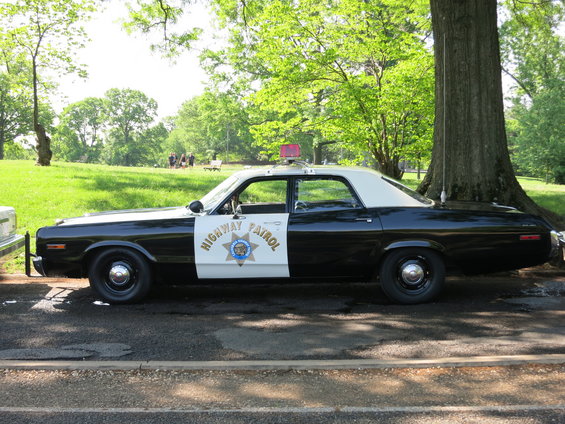 Black and white highway patrol car side view
