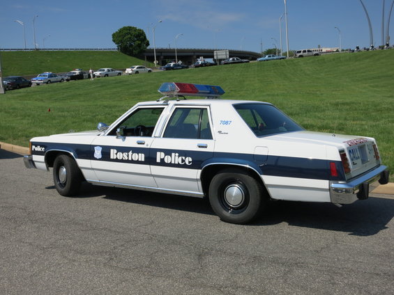 1991 Ford Crown Victoria police car, side view, white with blue stripe