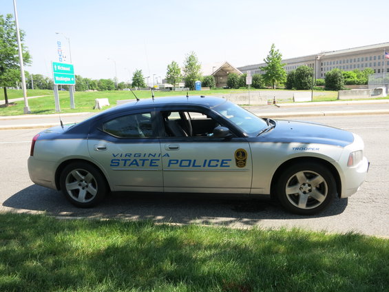 Virginia State Police car parked on roadside, side view. "VIRGINIA STATE POLICE" text visible
