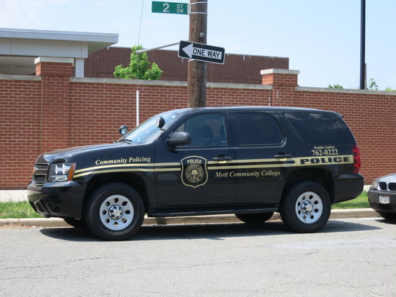 Black police SUV with 'Community Policing' and 'Mott Community College' text on the side