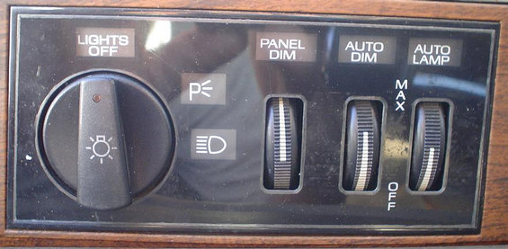 Dashboard light controls with knobs for panel dim, auto dim, and auto lamp. Also has a rotary dial for headlights