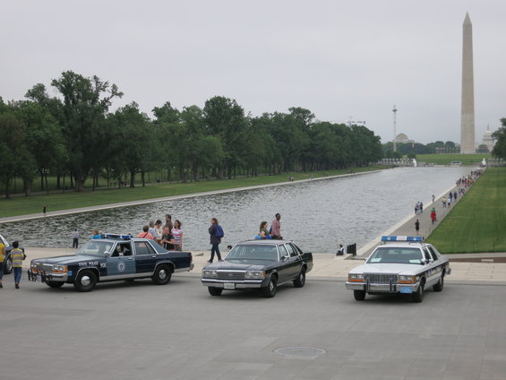 Three police cars parked in front of the Lincoln Memorial Reflecting Pool