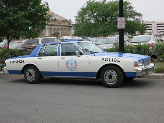 White and blue police car, side view