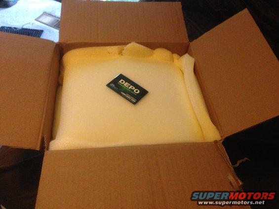 Card with "DEPO" logo inside a cardboard box with foam padding