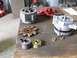 1992 Ford Bronco - Alternators and associated parts laid out on a wooden workbench for inspection or repair.