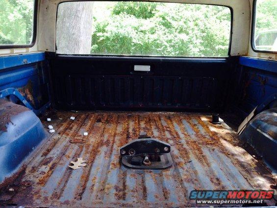 Rusted truck bed interior with hitch mechanism visible