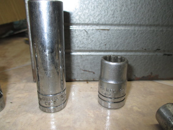 Two chrome socket wrenches, one longer than the other, with visible markings