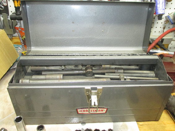 Metal toolbox with Craftsman logo and assorted tools inside