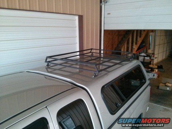 Truck with a cap and a metal roof rack installed