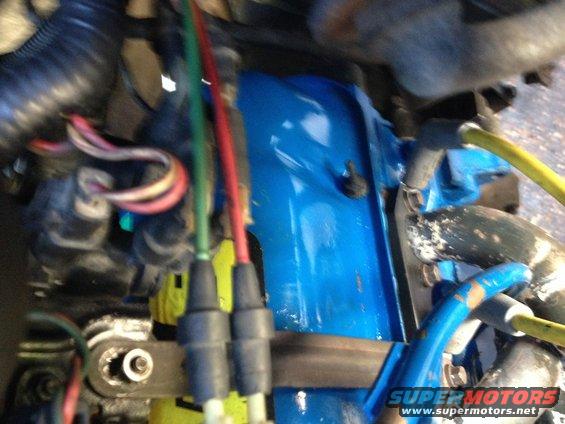 Close-up of engine bay wiring with blue painted component