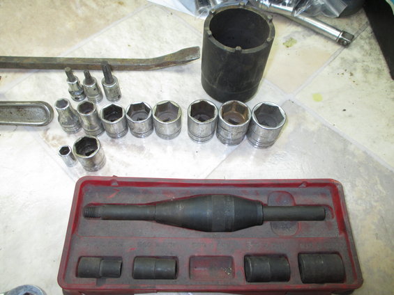 Tool set with sockets, a breaker bar, and a specialized tool in a red case