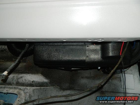 Underbody AC unit with wiring and black corrugated tubing