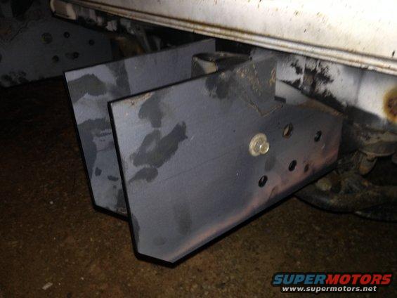 Custom steel brackets welded to a vehicle frame, likely for a rear bumper