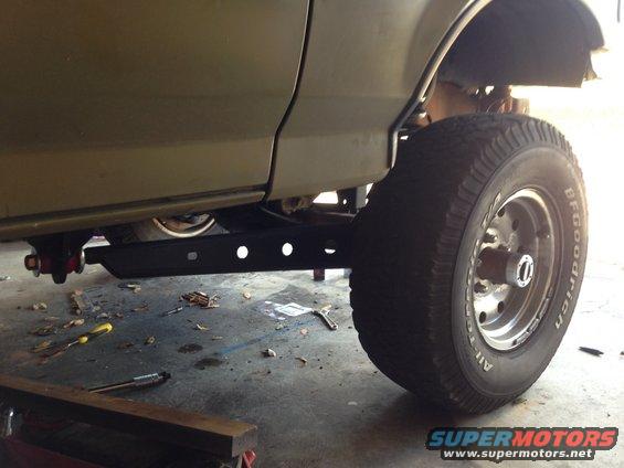 Olive green 1992 Ford Bronco side view, showing lifted suspension and large tire