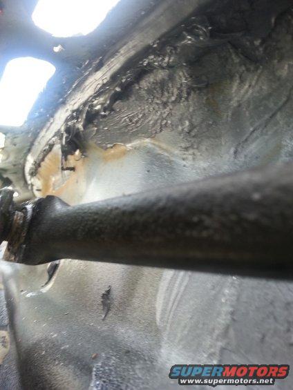 20140608_101004.jpg This is a picture from inside of the trough. In addition to applying the seam sealer along the seam at the top, I ran another coating across the bottom. At the far left of the picture you can also see a metal screw sticking through the firewall. I'm not sure if water could have been leaking there, but I covered that up as well.