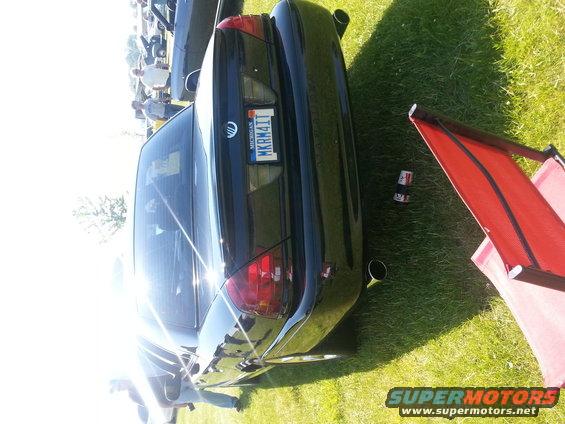 Black Mercury Grand Marquis parked on grass. Michigan license plate MKRM411