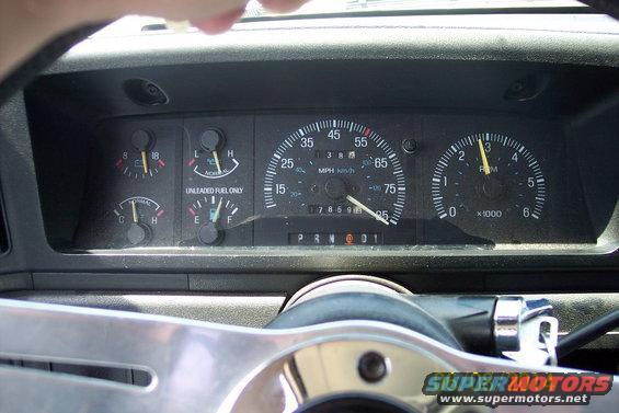 1990 Ford Bronco dashboard with speedometer, tachometer, fuel, and temperature gauges. Odometer reads 178699