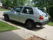 1985 Volkswagen GTI - A silver 1985 Volkswagen Golf is parked on a concrete driveway in front of a house.