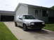 1985 Volkswagen GTI - A silver Volkswagen Golf Mk2 is parked on a concrete driveway in front of a suburban house.