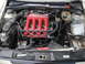 1985 Volkswagen GTI - Engine bay detail a red DOHC 16V intake manifold and silver exterior paint.