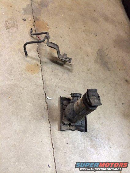 car jack and metal bracket on concrete floor