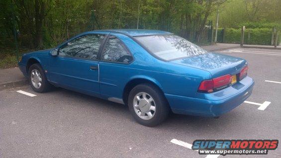 Blue 1994 Ford Thunderbird parked in a lot, rear view