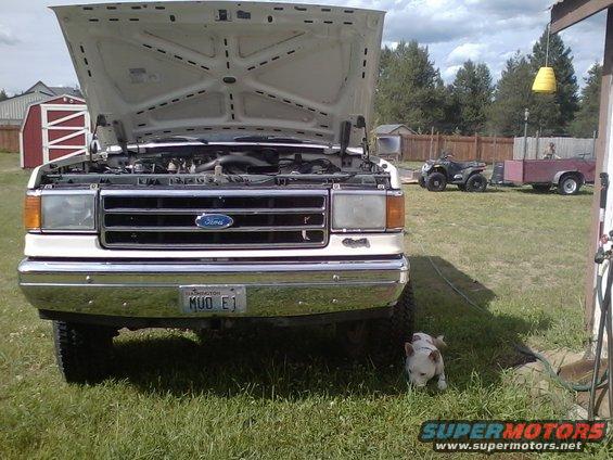 1987 Ford F-Series truck with hood open, Washington license plate MUD E1. ATV and trailer in background