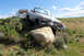 1989 Ford Bronco - Ford F-Series truck is stuck on a rock with another vehicle visible in the background.