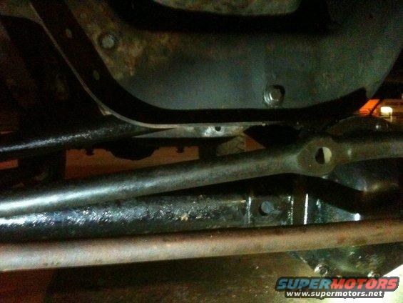 Close-up of vehicle steering linkage components, possibly from a solid axle swap
