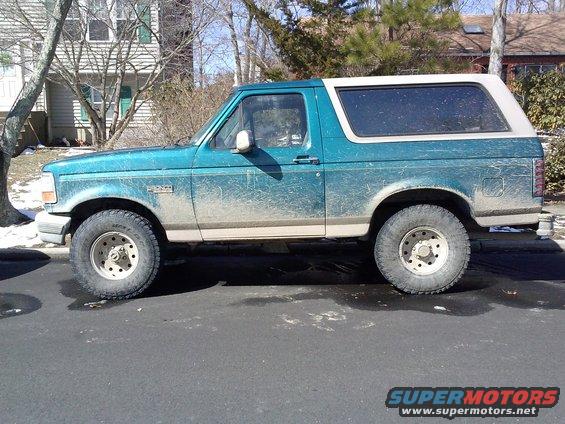 Side view of a teal 1996 Ford Bronco parked on a street