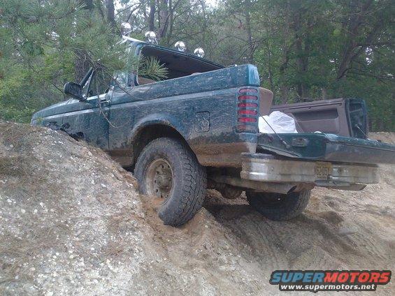 1996 Ford Bronco stuck in dirt, rear view