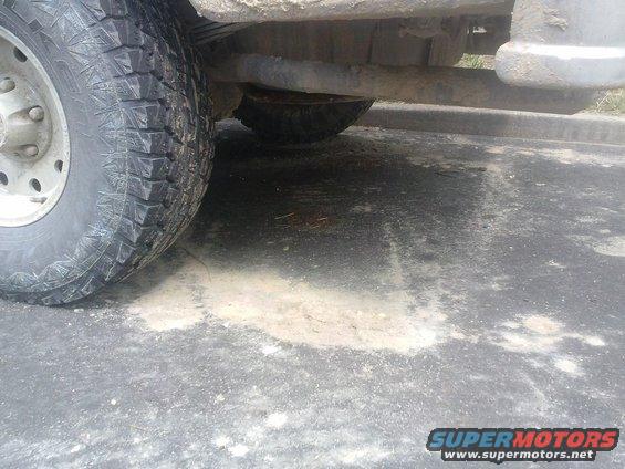 Close-up of a large tire and undercarriage of a vehicle