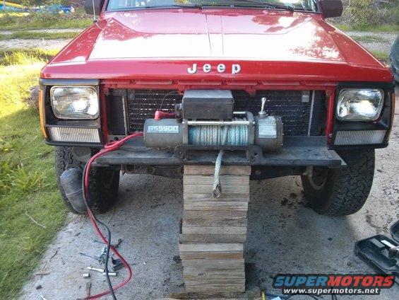 Red Jeep Cherokee front with winch and tow rope