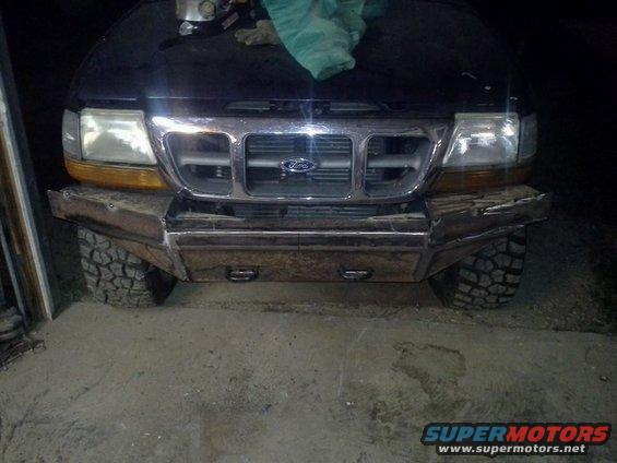 Black Ford Ranger front with custom metal bumper, off-road tires, and Ford grille