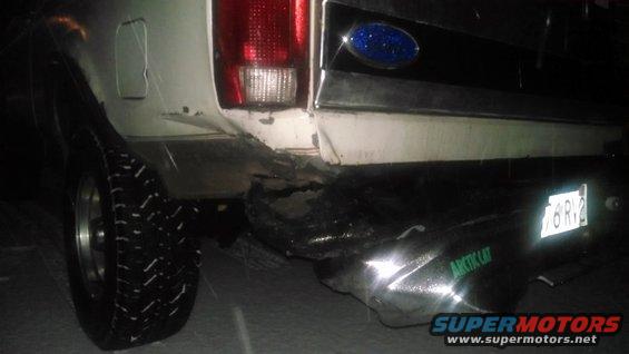 White Ford Bronco rear bumper damaged, with Arctic Cat branding on a chrome aftermarket bumper. License plate 76 RV2 is visible