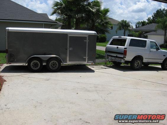 Wells cargo dual axle enclosed trailer with a gutter machine mounted inside. The PO had the roof chopped and lowered to fit in a garage.