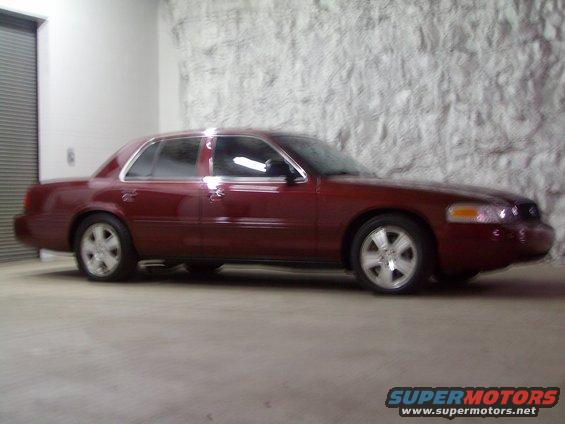 Red 2004 Ford Crown Victoria sedan, side view