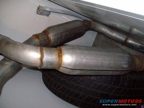 Exhaust system pipes and spare tire