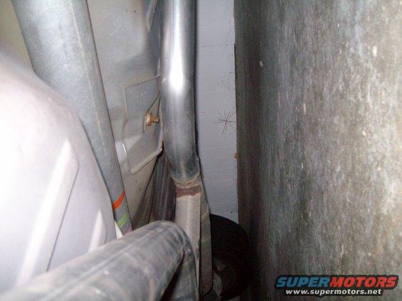 Underbody view showing exhaust pipe and part of the fuel tank area