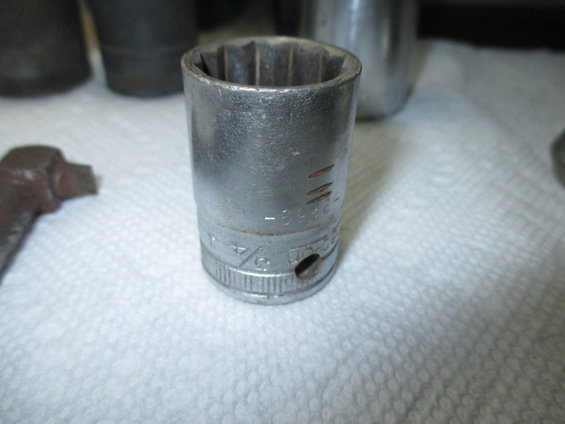 Socket wrench part with markings and a 3/4 inch size indicator