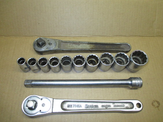 Socket wrench set with two ratchets, extension bar, and multiple sockets on a cardboard surface