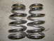 1957 Ford Ranchero - Two chrome coil springs are shown, likely for a vehicle suspension system.