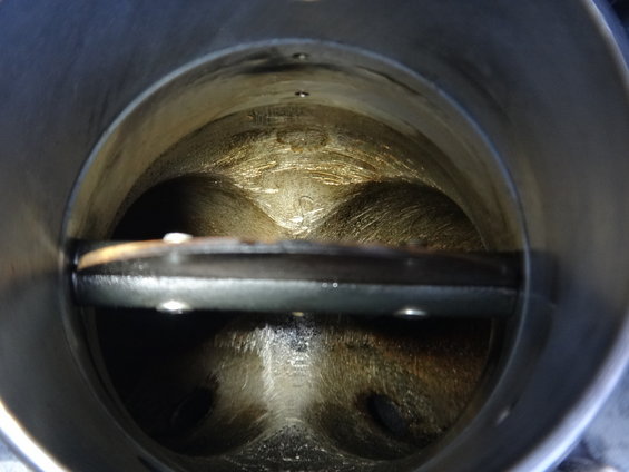Inside of a dirty throttle body with the butterfly valve visible