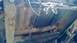 1983 Ford Bronco - The underside of a vehicle chassis shows significant rust and exposed wiring, with suspension components visible.