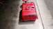 1983 Ford Bronco - A red fuel tank sits on a stool, likely in a garage or workshop.