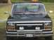 1983 Ford Bronco - This black 1983 Ford Bronco is shown from the front, its chrome grille and bumper.