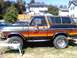 1979 Ford Bronco - This classic Ford Bronco features a distinctive orange, yellow, and red stripe graphic along its side.