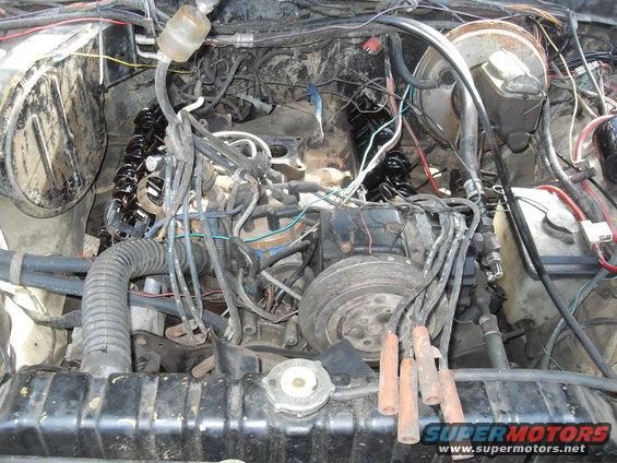 Engine bay with V8 engine, radiator, and wiring visible