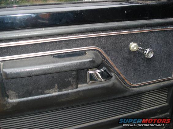 Interior door panel with chrome window crank and handle