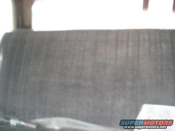 Close-up of a dark, textured seat inside a vehicle